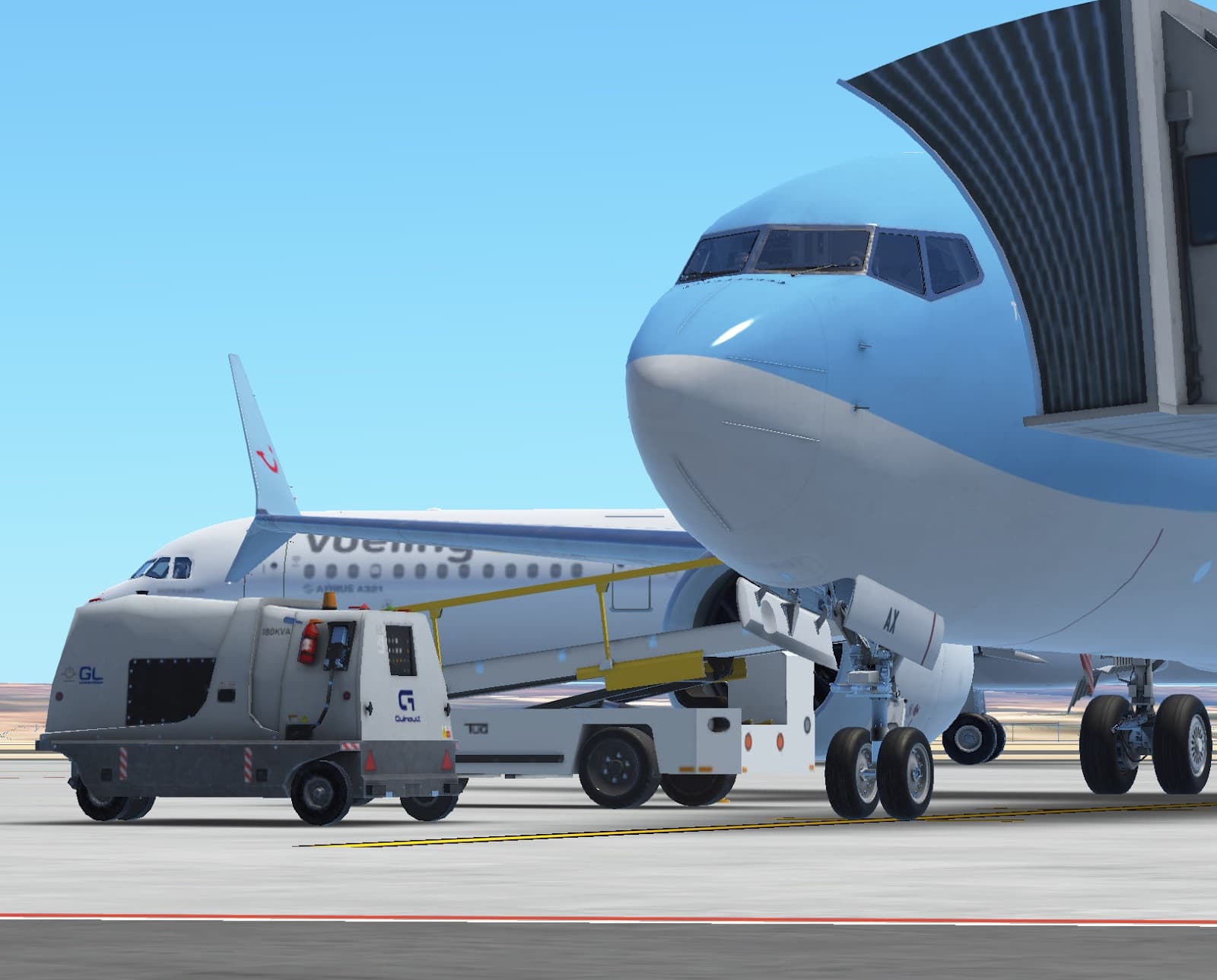 The nose of a TUI Boeing 737 at the gate, with a Vueling aircraft behind